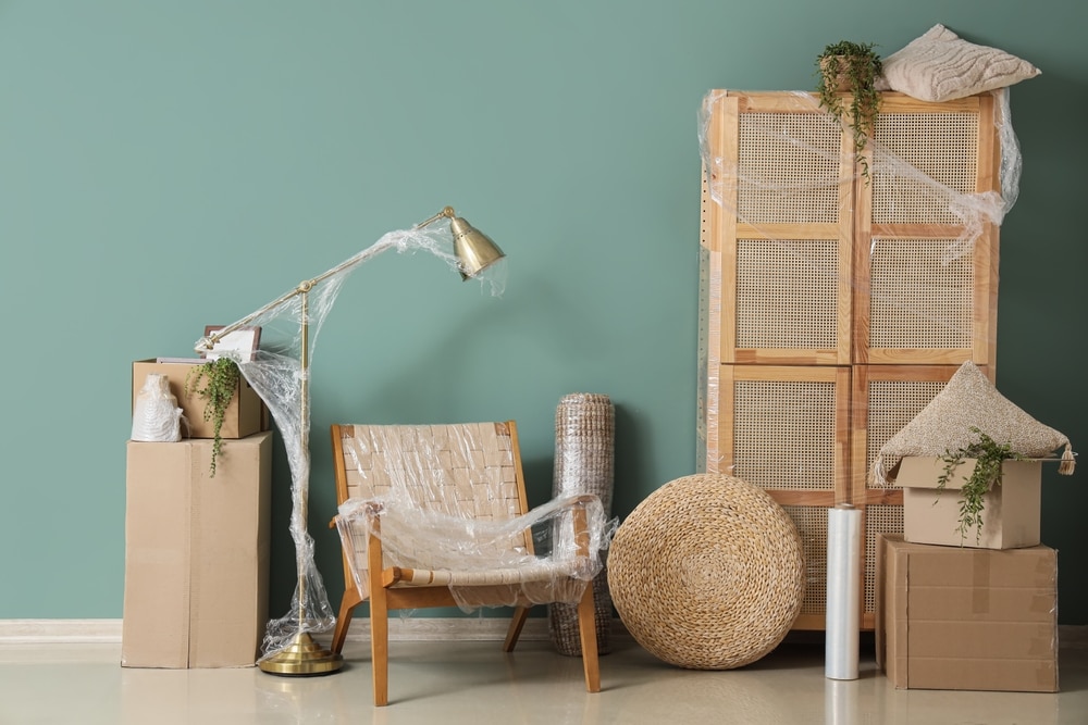 Wrapped,Furniture,With,Stretch,Film,And,Boxes,Near,Green,Wall