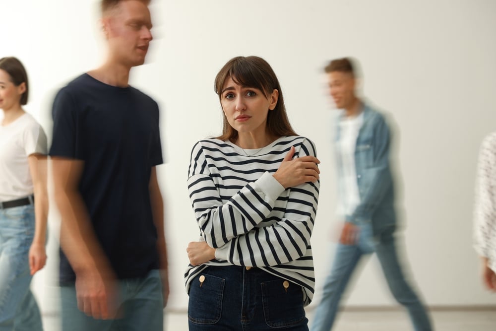 Young,Woman,Feeling,Uncomfortable,Among,People,Indoors